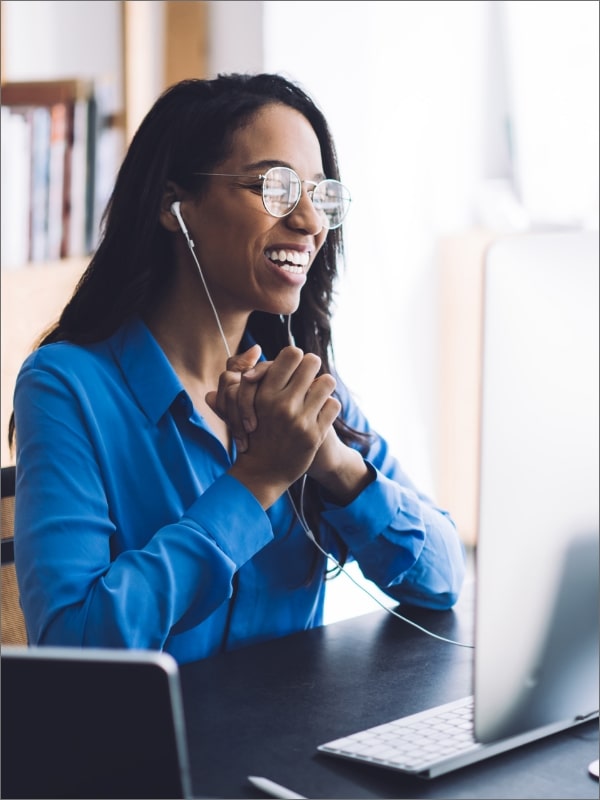 Happy lady sitting in front of a computer