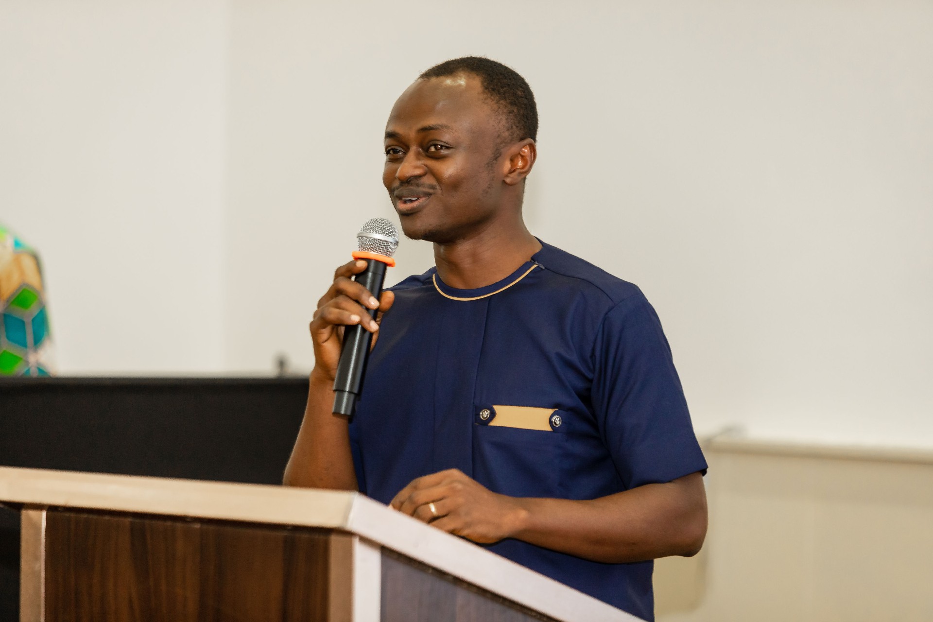 A man holding a microphone speaking