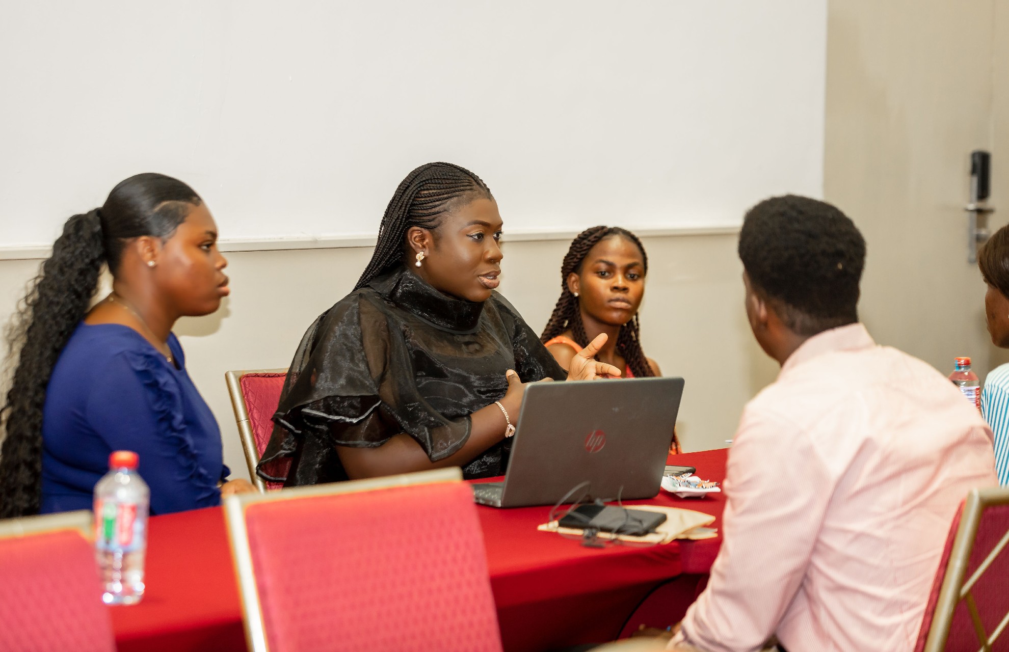 A small group of people having a discussion seated