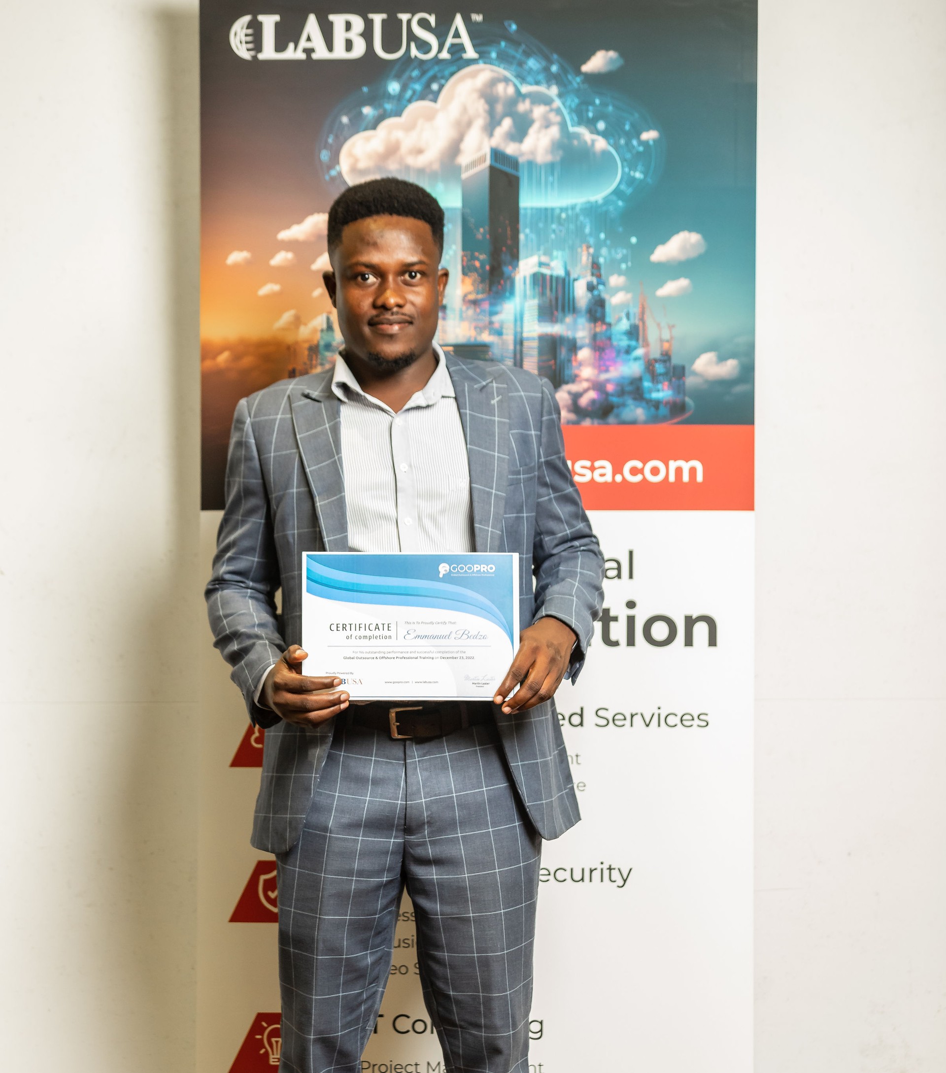 A man in a suit holding a certificate