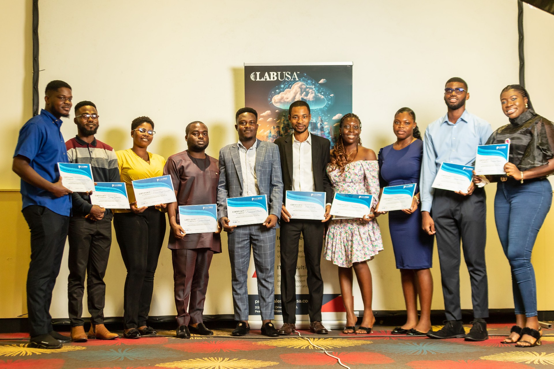 A group of people holding certificates and posing